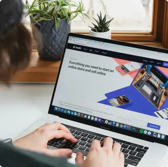 Person working on a laptop building an online store, illustrating web development services